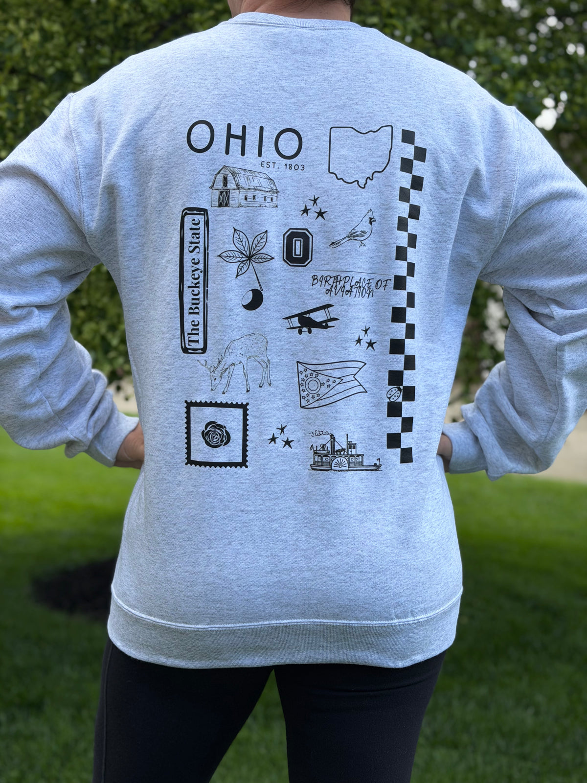 Gray sweatshirt with black state of Ohio symbols and 'OHIO' text on the back, worn by a person outdoors.