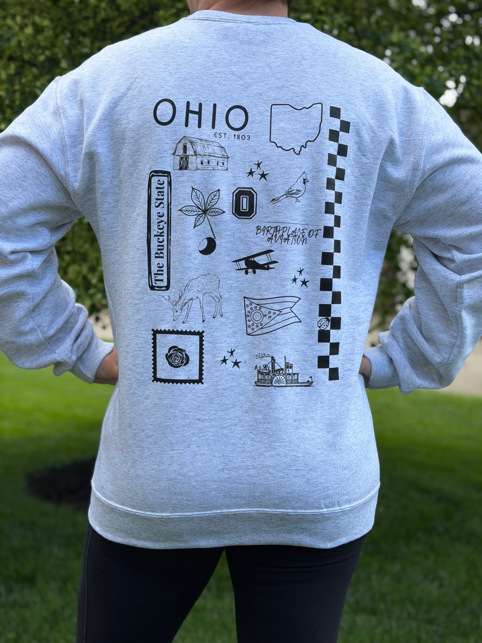 Gray sweatshirt with black state of Ohio symbols and 'OHIO' text on the back, worn by a person outdoors.
