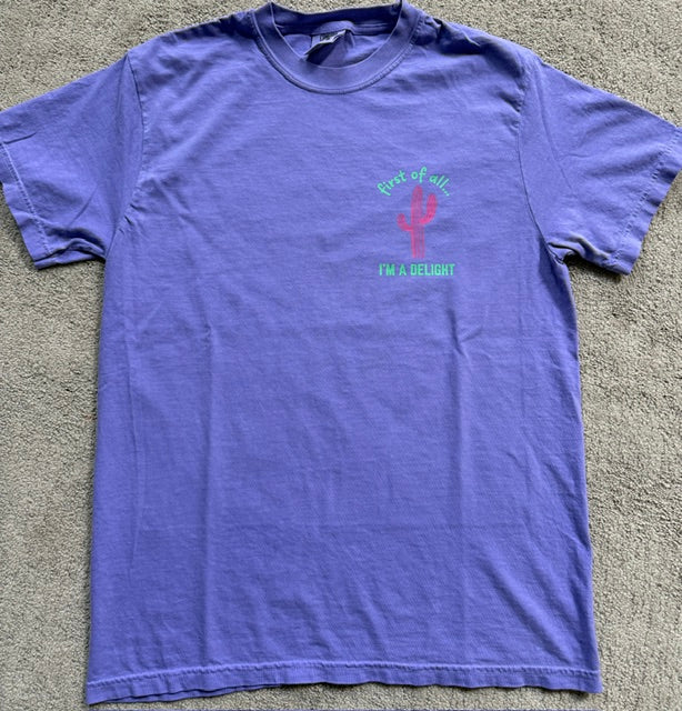 Violet fabric t-shirt with a cactus graphic and text on a violet background